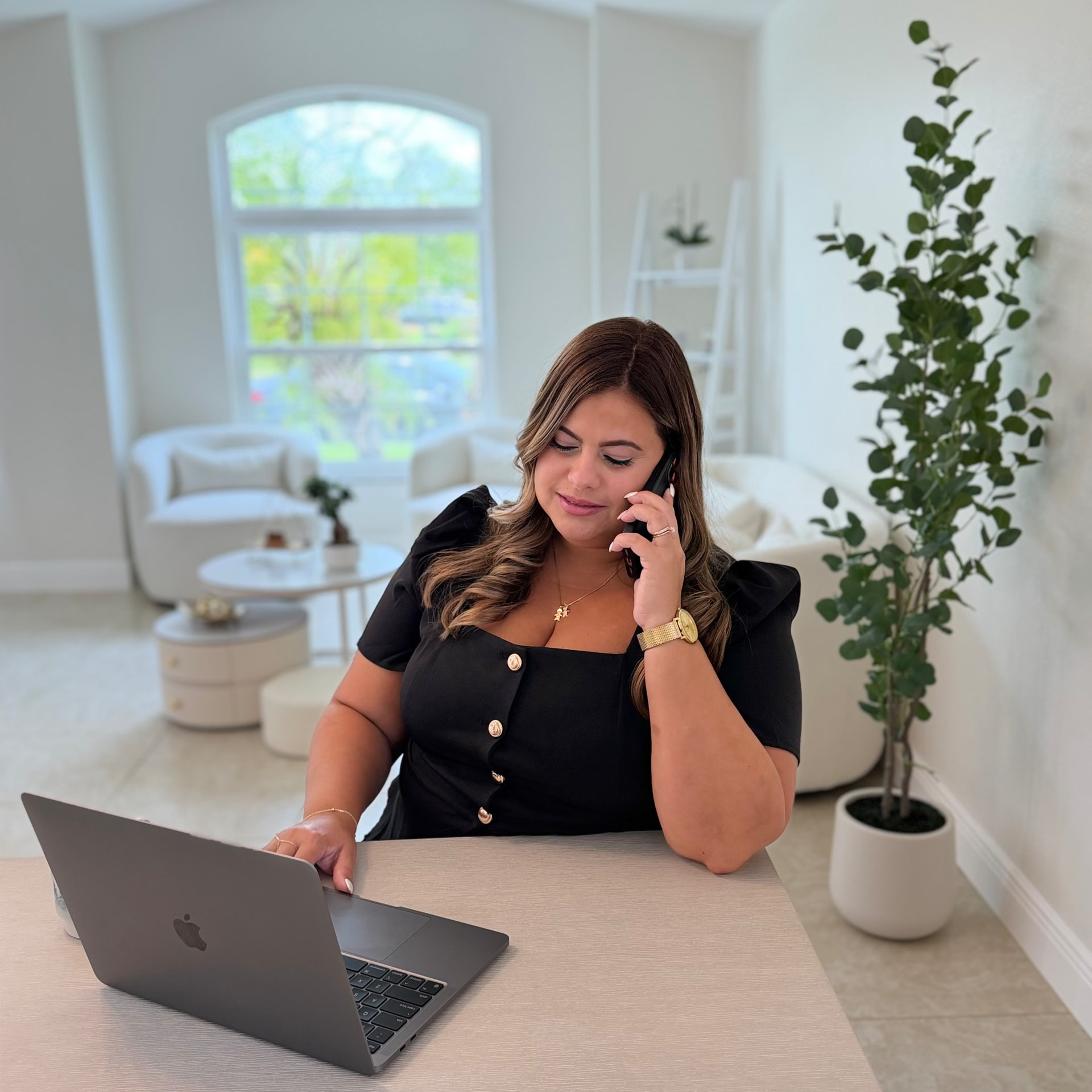 Marisel Grillo Autie working with a client by phone